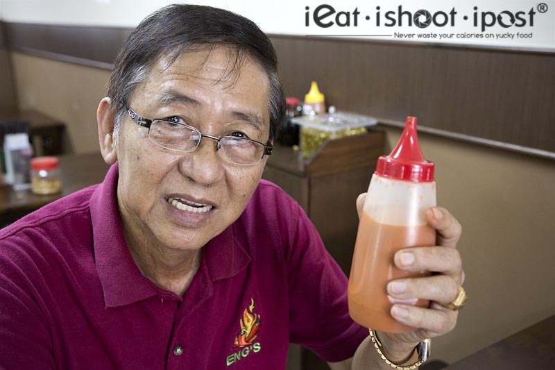 Mr Ng (Eng), 2nd Gen owner with his bottle of potent chilli sauce