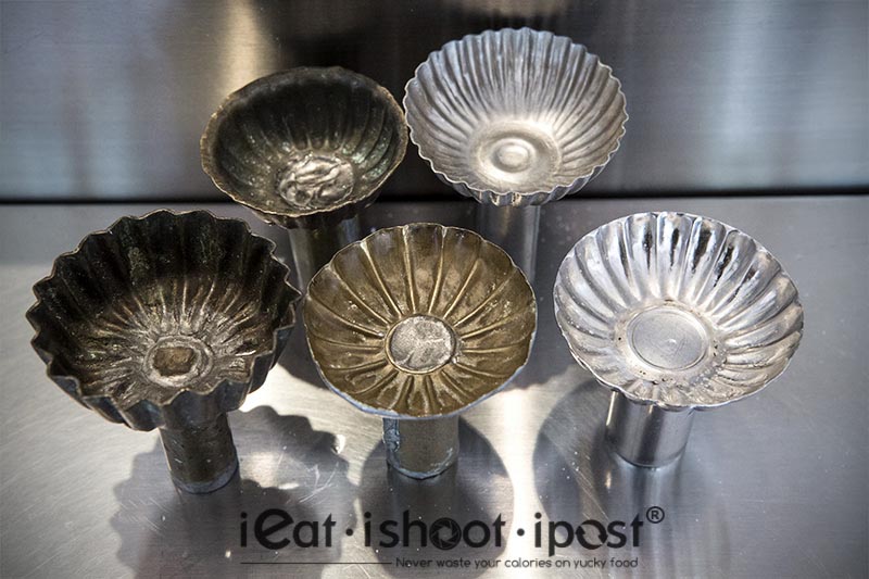 Generations of Kueh Tutu mold from the early brass molds to present day stainless steel