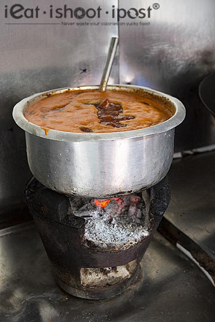 Assam Pedas cooking over charcoal