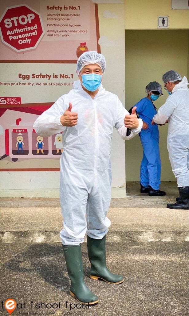 Dr Leslie Tay donning a body suit after a bath for Bio-Security