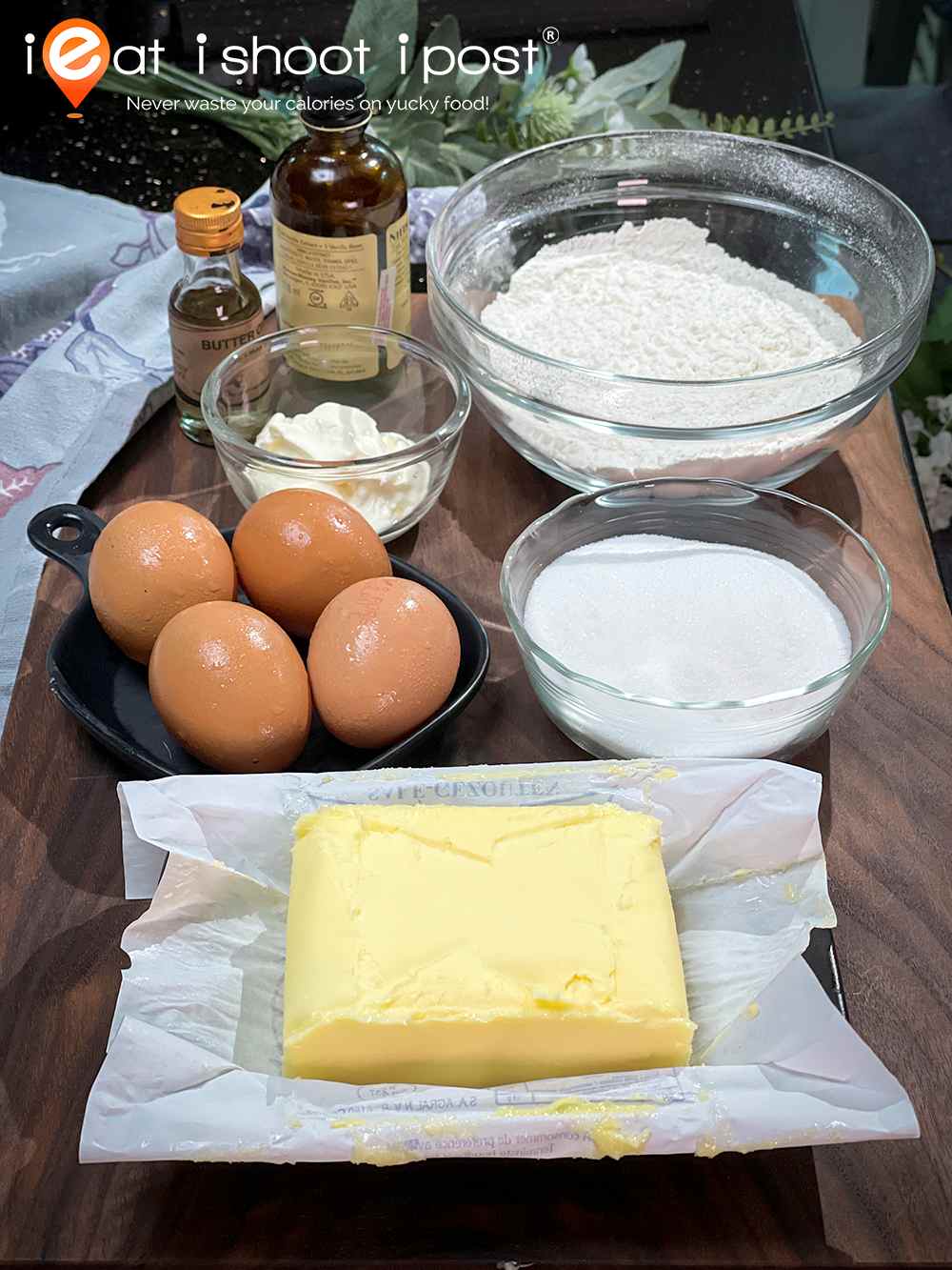 Ingredients from front to back - 250g block of Butter, 4 x 60g eggs, 150g castor sugar, 45g sour cream, 180g self-raising flour, vanilla essence and butter oil